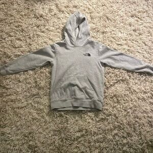 A grey kids never stop exploring sweatshirt. Size 10-12.
